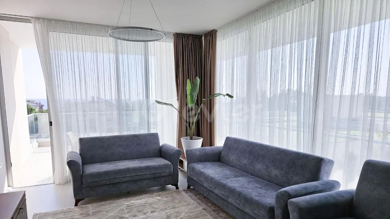 Bright corner living room with two sofas and full-height windows